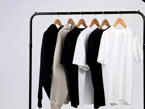 Hoodies and tees hanging on a clothing rack