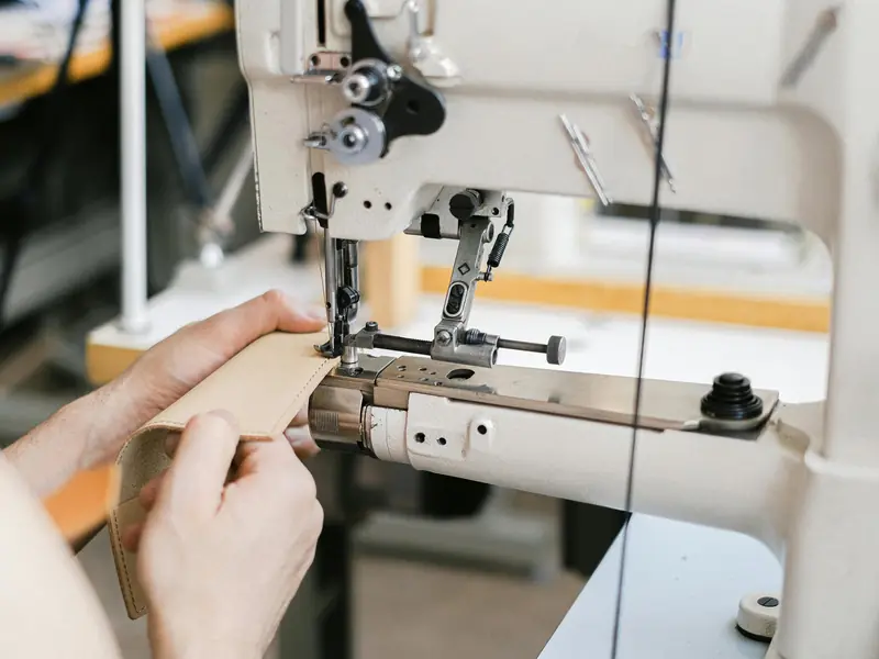 Sewing machinist stitching a sample